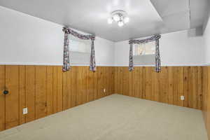 Spare room featuring a wainscoted wall and wood walls