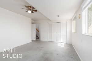 Unfurnished bedroom featuring baseboards, carpet floors, a closet, and multiple windows
