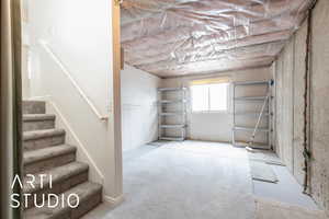 Basement with carpet and stairs