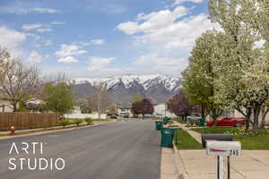 View of street featuring curbs, sidewalks, and a mountain view