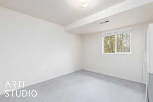 Carpeted empty room featuring baseboards and visible vents