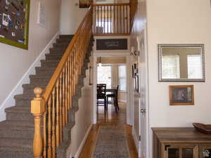 Staircase with baseboards and wood finished floors