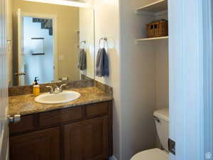 1/2 Bathroom with toilet and vanity