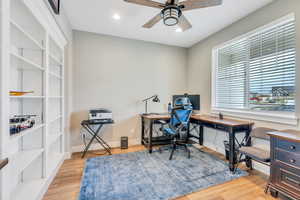 Home office with baseboards, a ceiling fan, wood finished floors, and recessed lighting