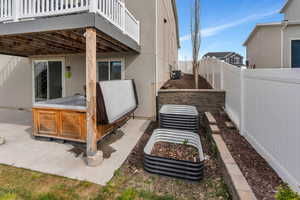View of patio / terrace featuring a fenced backyard, central AC unit, a hot tub, and a deck