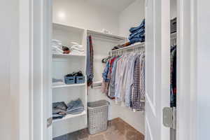 Walk in closet with carpet flooring
