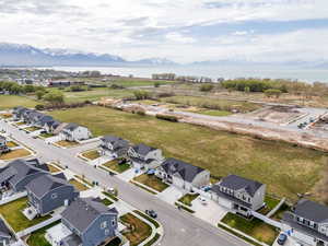 Birds eye view of property featuring a water and mountain view and a residential view