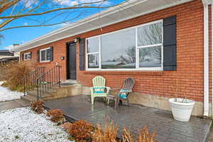 Exterior space with brick siding and a patio