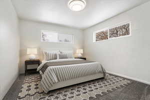 Carpeted bedroom featuring baseboards