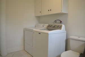 Laundry area featuring marble finish floor, separate washer and dryer, and laundry area