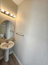 Bathroom with baseboards and wood finished floors