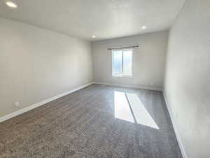 Unfurnished room featuring baseboards, carpet flooring, a textured ceiling, and recessed lighting