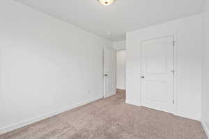 Unfurnished bedroom with baseboards and carpet flooring