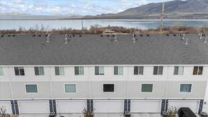 Birds eye view of property featuring a water and mountain view