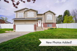 Beautiful home in a cul de sac with fence, a front lawn, brick siding, and a garage
