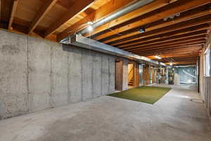 Unfinished basement featuring heating unit