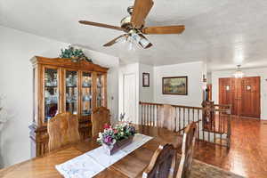 Dining area with a textured ceiling and ceiling fan