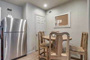 Dining room featuring light tile flooring and recessed lighting