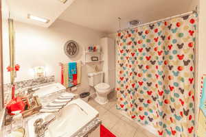 Full bathroom in basement with dual vanity.