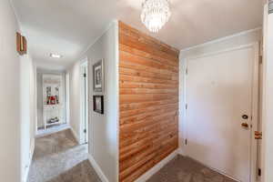 Entry into home. Bedrooms to the right, kitchen to the left, living room straight ahead. Lots of accent wall features in this home.