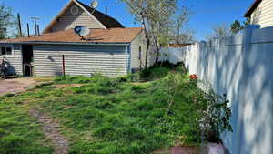 back yard with fence and roof with shingles
