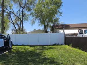 front yard with 3 parking space and gate opens to drive into back yard