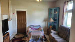 Sitting room featuring tile patterned floors and baseboards
