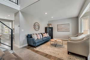 Living room with LVP flooring, bay window and plantation shutters