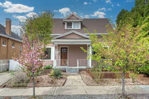 View of front of house with roof with shingles and a porch
