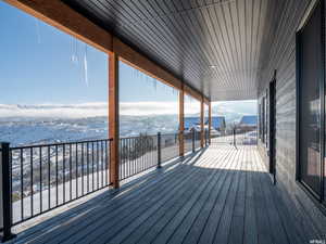 Snow covered deck with a mountain view