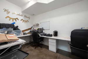 Home office featuring concrete floors and visible vents