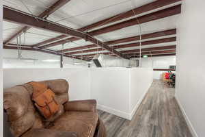 Below grade area with baseboards and wood finished floors