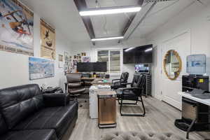 Home office with light wood finished floors