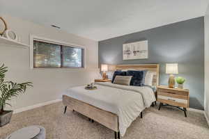 Carpeted bedroom featuring baseboards