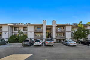 View of building exterior with uncovered parking