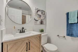 Full bathroom with vanity and toilet