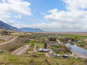 Birds eye view of property with a water and mountain view