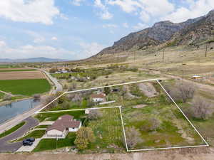 Aerial view featuring a rural view and a water and mountain view