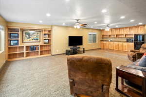 Family room featuring recessed lighting, a ceiling fan, built-in shelving