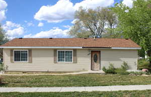 Single story home with a front lawn and roof with shingles