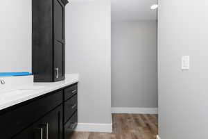 Bathroom featuring vanity and wood finished floors
