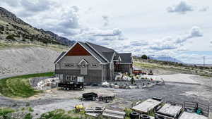 Back of house with a mountain view and brick siding