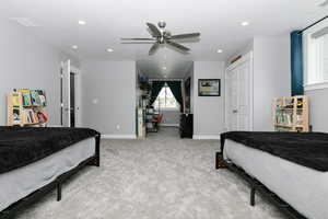 Carpeted bedroom featuring recessed lighting and ceiling fan