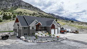 View of front of property featuring concrete driveway, a mountain view, a garage, and brick siding