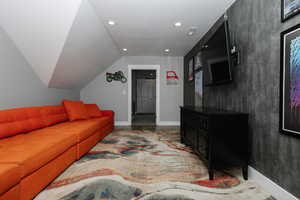 Living room featuring recessed lighting and vaulted ceiling