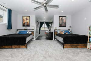 Carpeted bedroom with recessed lighting and a ceiling fan