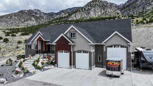 View of front of house featuring a mountain view, stucco siding, and driveway