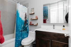 Full bath featuring vanity and shower / bath combination with curtain