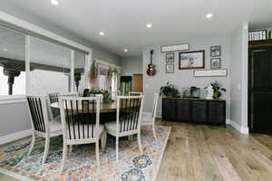 Dining space featuring plenty of natural light, hardwood / wood-style floors, and recessed lighting