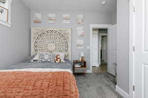 Bedroom with carpet flooring and baseboards